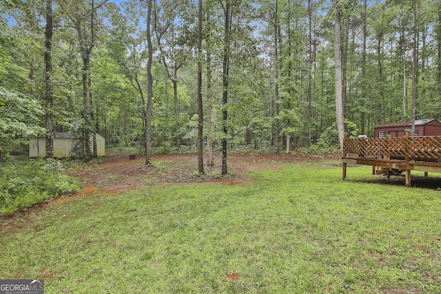 279 Brenna Ct, Luthersville, GA 30251 - view of grassy yard with a wooden deck and a forest view