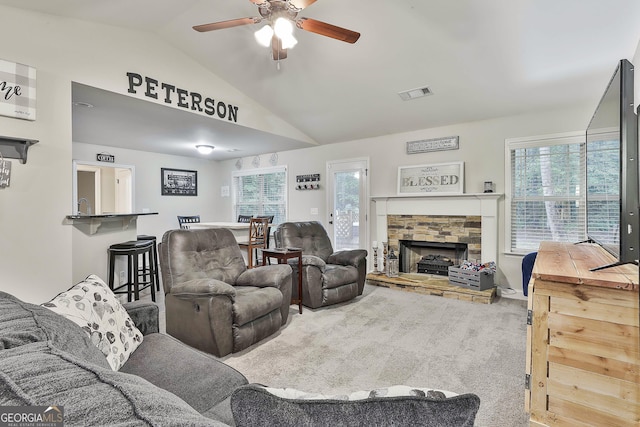 279 Brenna Ct, Luthersville, GA 30251 - carpeted living area with lofted ceiling, ceiling fan, and a stone fireplace