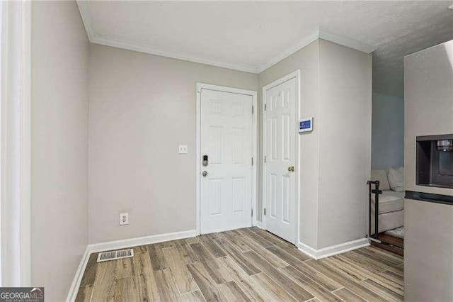 3351 Landrum Dr SE, Smyrna, GA 30082 - entryway featuring crown molding, wood finished floors, and baseboards