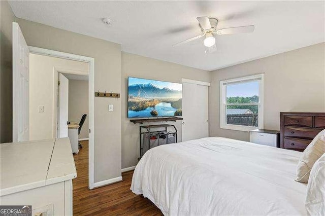 3351 Landrum Dr SE, Smyrna, GA 30082 - bedroom featuring dark wood-type flooring, baseboards, ceiling fan, and a closet