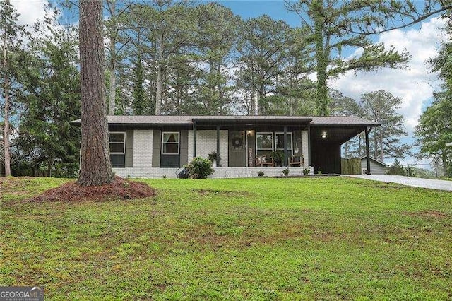 3351 Landrum Dr SE, Smyrna, GA 30082 - view of front facade with driveway, a carport, a front yard, and brick siding