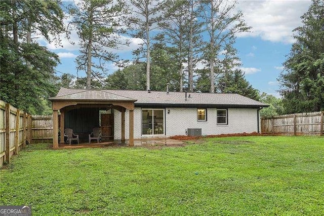 3351 Landrum Dr SE, Smyrna, GA 30082 - rear view of property with central AC unit, brick siding, and a gazebo
