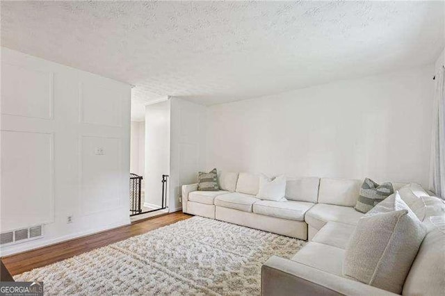 3351 Landrum Dr SE, Smyrna, GA 30082 - living area with wood finished floors and a textured ceiling