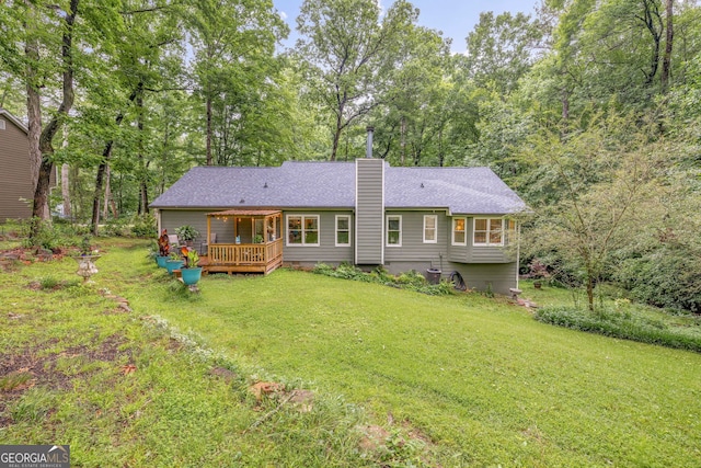 1526 Oakleaf Dr, Auburn, GA 30011 - rear view of property with a deck, a yard, a chimney, and a shingled roof