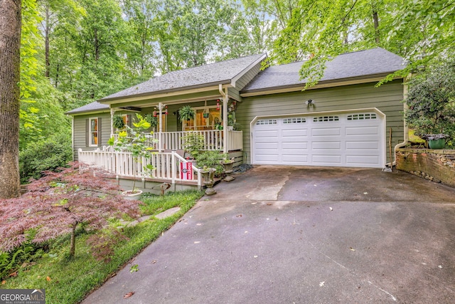 1526 Oakleaf Dr, Auburn, GA 30011 - ranch-style house featuring a porch, asphalt driveway, a garage, and roof with shingles