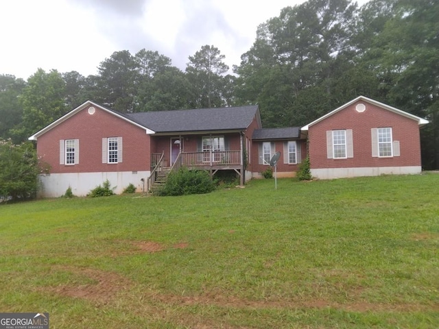 390 Burg Rd, Locust Grove, GA 30248 - ranch-style house featuring a front yard, brick siding, a porch, and view of scattered trees