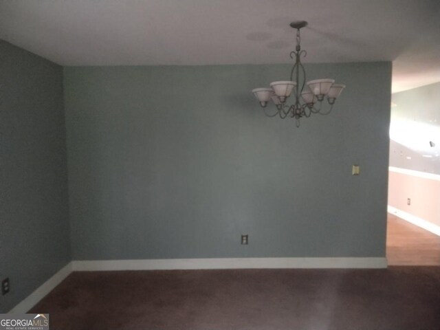 390 Burg Rd, Locust Grove, GA 30248 - spare room with a chandelier and baseboards