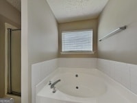 426 Summer Hill Cir, Stockbridge, GA 30281 - bathroom with a garden tub and a stall shower