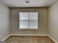 426 Summer Hill Cir, Stockbridge, GA 30281 - spare room featuring carpet floors and baseboards
