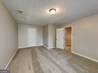 426 Summer Hill Cir, Stockbridge, GA 30281 - unfurnished room with baseboards and a textured ceiling