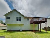 426 Summer Hill Cir, Stockbridge, GA 30281 - back of house with a wooden deck and a yard