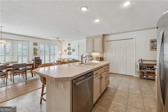440 Carybell Ln, Alpharetta, GA 30004 - kitchen with appliances with stainless steel finishes, a sink, a textured ceiling, light countertops, and a kitchen island with sink