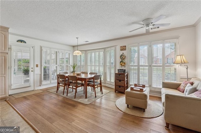 440 Carybell Ln, Alpharetta, GA 30004 - dining space with a textured ceiling, light wood finished floors, crown molding, and a ceiling fan