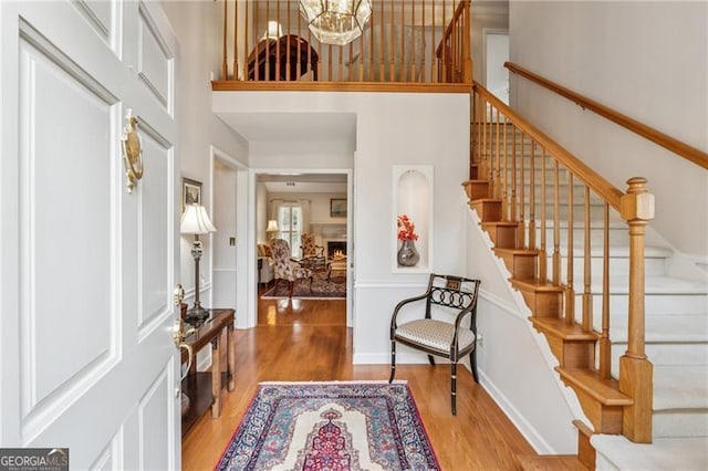 440 Carybell Ln, Alpharetta, GA 30004 - entrance foyer with wood finished floors, stairway, a high ceiling, and a chandelier