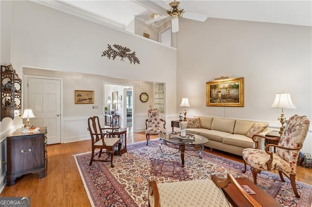 440 Carybell Ln, Alpharetta, GA 30004 - living room with ceiling fan, wood finished floors, wainscoting, high vaulted ceiling, and a decorative wall