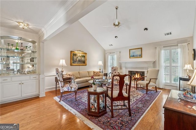 440 Carybell Ln, Alpharetta, GA 30004 - living area featuring ceiling fan, light wood-type flooring, a glass covered fireplace, lofted ceiling, and crown molding