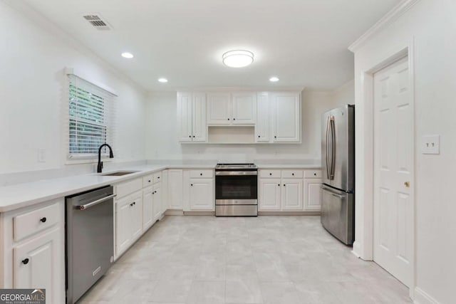 1245 Ladd St SW, Atlanta, GA 30310 - kitchen with appliances with stainless steel finishes, white cabinets, recessed lighting, light countertops, and ornamental molding