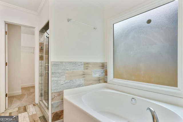 1245 Ladd St SW, Atlanta, GA 30310 - bathroom featuring ornamental molding, a bath, a spacious closet, and a stall shower