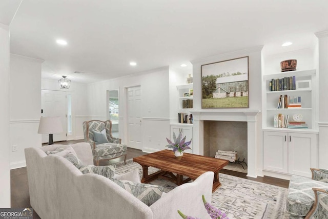 1245 Ladd St SW, Atlanta, GA 30310 - living room with ornamental molding, dark wood finished floors, a tiled fireplace, built in shelves, and recessed lighting