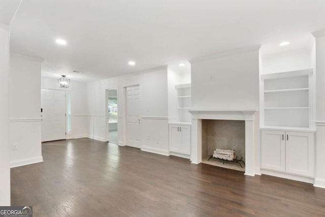 1245 Ladd St SW, Atlanta, GA 30310 - unfurnished living room with built in features, crown molding, dark wood-style floors, recessed lighting, and a tiled fireplace