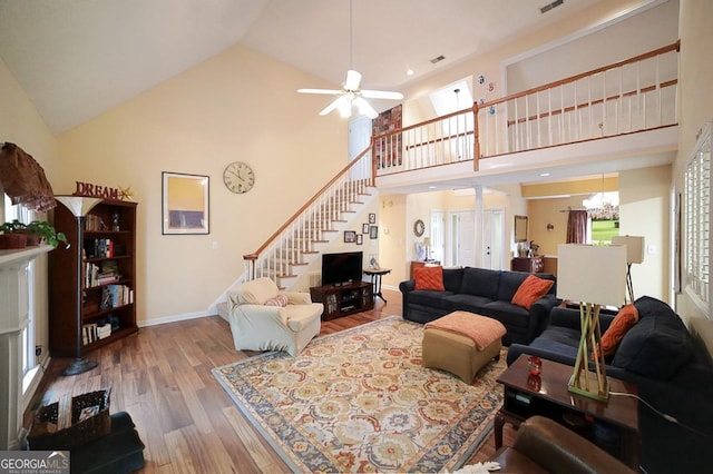 1010 Calls Creek Cir, Watkinsville, GA 30677 - living area featuring stairway, hardwood / wood-style floors, high vaulted ceiling, ceiling fan, and a chandelier
