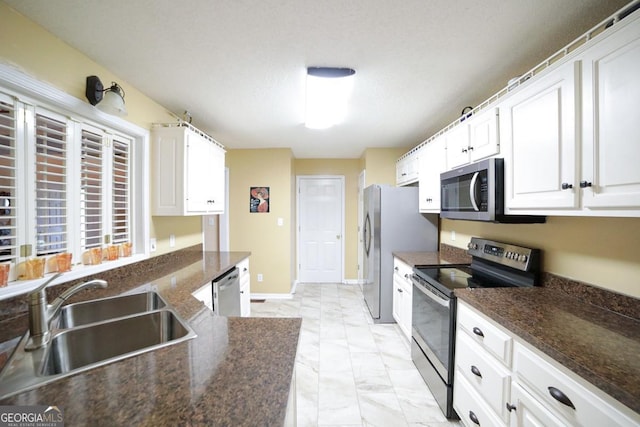 1010 Calls Creek Cir, Watkinsville, GA 30677 - kitchen with stainless steel appliances, a sink, light marble finish flooring, and white cabinetry
