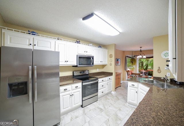 1010 Calls Creek Cir, Watkinsville, GA 30677 - kitchen featuring stainless steel appliances, a sink, dark countertops, light marble finish flooring, and white cabinets