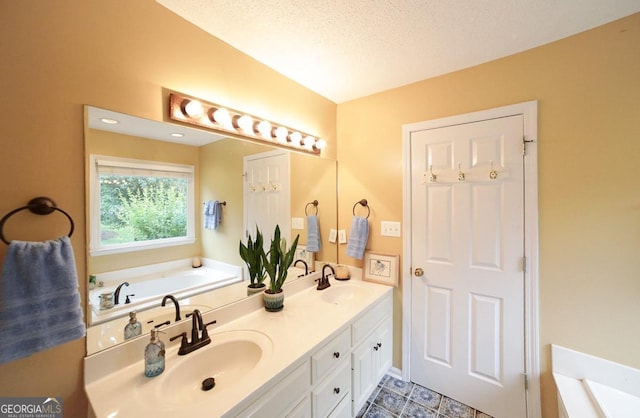 1010 Calls Creek Cir, Watkinsville, GA 30677 - bathroom featuring a garden tub, double vanity, and a textured ceiling
