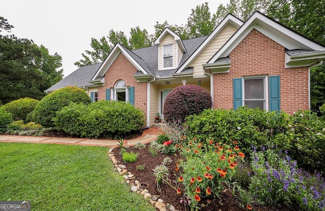 1010 Calls Creek Cir, Watkinsville, GA 30677 - traditional-style house featuring brick siding, a front yard, and roof with shingles