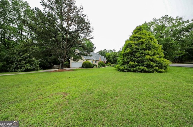 1010 Calls Creek Cir, Watkinsville, GA 30677 - view of grassy yard featuring a garage and view of scattered trees