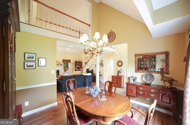 1010 Calls Creek Cir, Watkinsville, GA 30677 - dining area with stairway, wood finished floors, high vaulted ceiling, baseboards, and a skylight