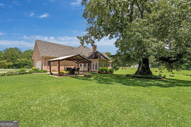 10 Wigwam Cir, Whitesburg, GA 30185 - view of grassy yard featuring an attached garage, a patio area, and french doors
