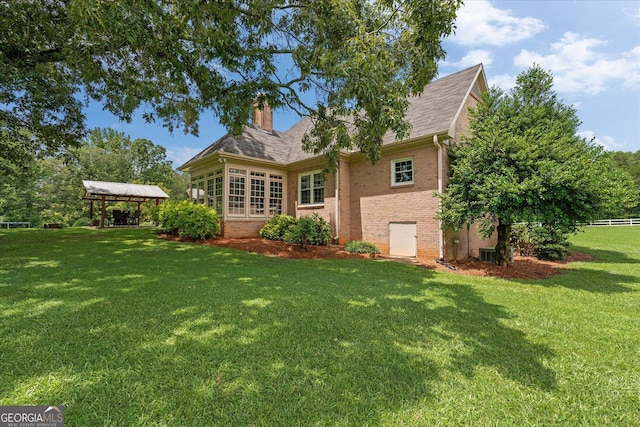 10 Wigwam Cir, Whitesburg, GA 30185 - rear view of house featuring brick siding, a lawn, a gazebo, a chimney, and a shingled roof