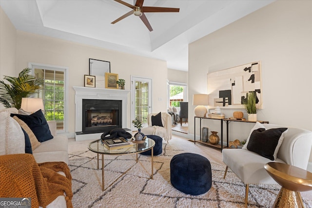 10 Wigwam Cir, Whitesburg, GA 30185 - living area featuring ceiling fan, a fireplace with raised hearth, and a raised ceiling