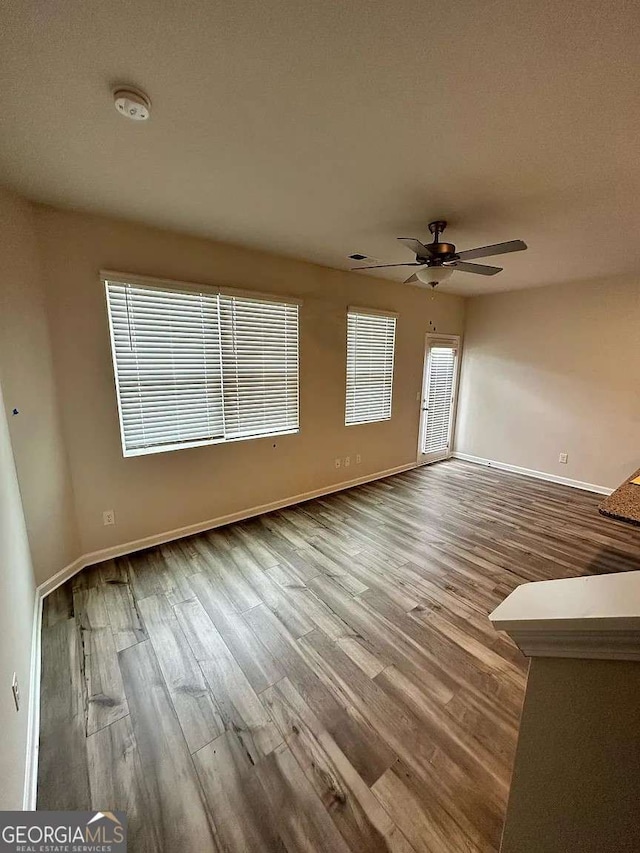 2832 Saratoga Lake Vw, Decatur, GA 30034 - unfurnished living room featuring wood finished floors, ceiling fan, and baseboards