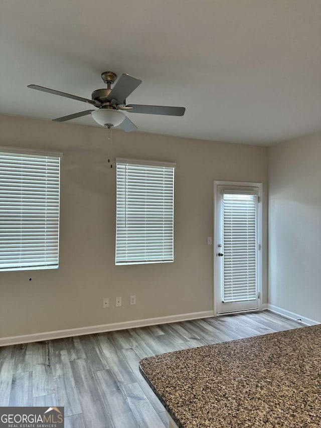 2832 Saratoga Lake Vw, Decatur, GA 30034 - spare room with wood finished floors, baseboards, and ceiling fan