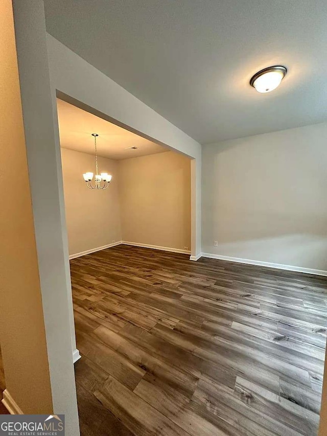 2832 Saratoga Lake Vw, Decatur, GA 30034 - empty room with dark wood-style flooring, baseboards, and a chandelier