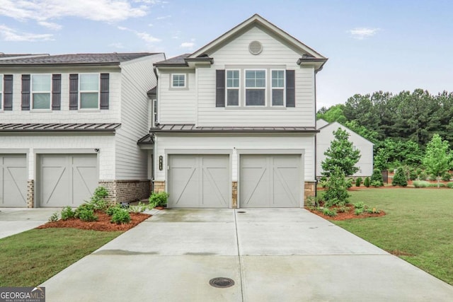 3848 Hester St, Duluth, GA 30097 - view of front of home featuring a garage, a standing seam roof, a front lawn, and concrete driveway