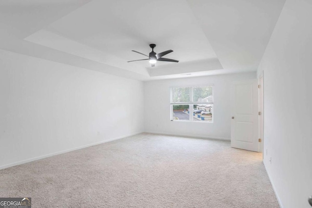 3848 Hester St, Duluth, GA 30097 - unfurnished room featuring a raised ceiling, light carpet, and a ceiling fan