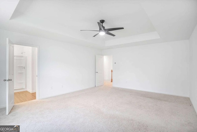 3848 Hester St, Duluth, GA 30097 - carpeted spare room with a tray ceiling and a ceiling fan