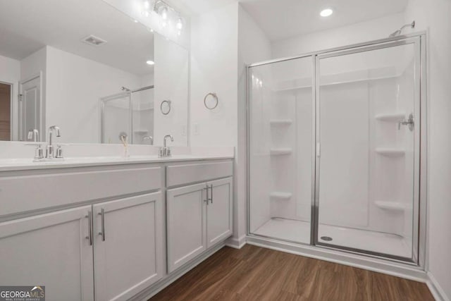 3848 Hester St, Duluth, GA 30097 - full bathroom featuring a shower stall, wood finished floors, double vanity, and recessed lighting