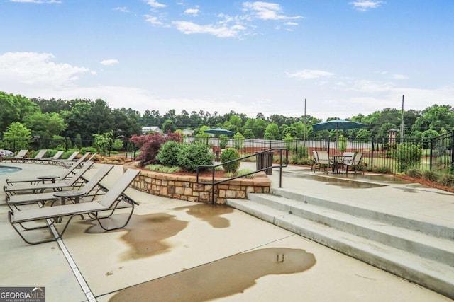 3848 Hester St, Duluth, GA 30097 - view of home's community with a patio, view of wooded area, and a swimming pool