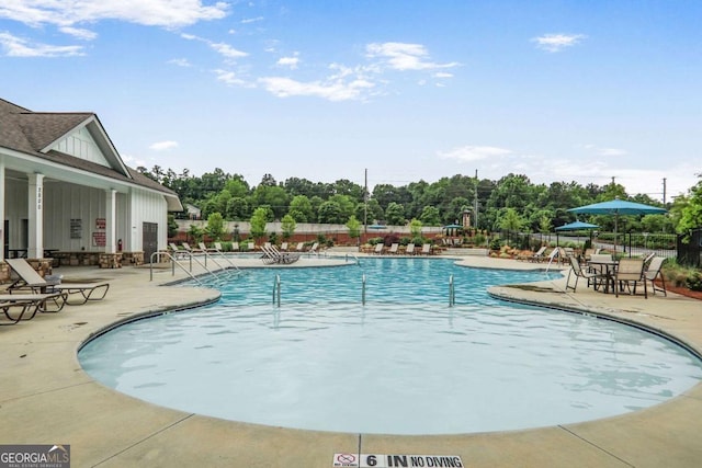 3848 Hester St, Duluth, GA 30097 - community pool featuring a patio and view of scattered trees