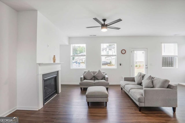 3848 Hester St, Duluth, GA 30097 - living area featuring plenty of natural light, dark wood-style floors, a glass covered fireplace, and a ceiling fan