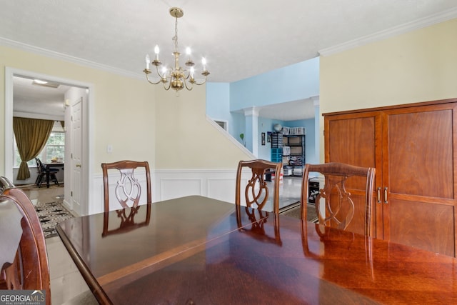 570 White Stag Ct, Suwanee, GA 30024 - dining area featuring crown molding, a chandelier, and a wainscoted wall