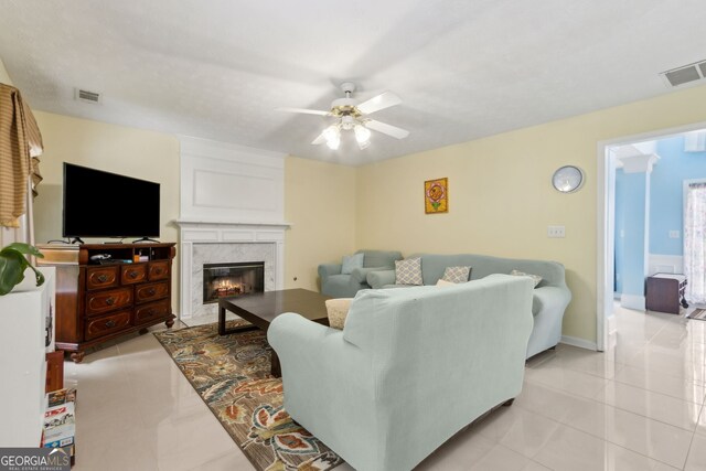 570 White Stag Ct, Suwanee, GA 30024 - living room with ceiling fan, light tile patterned floors, and a high end fireplace