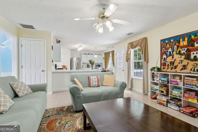 570 White Stag Ct, Suwanee, GA 30024 - living area with light tile patterned floors, a ceiling fan, and a textured ceiling