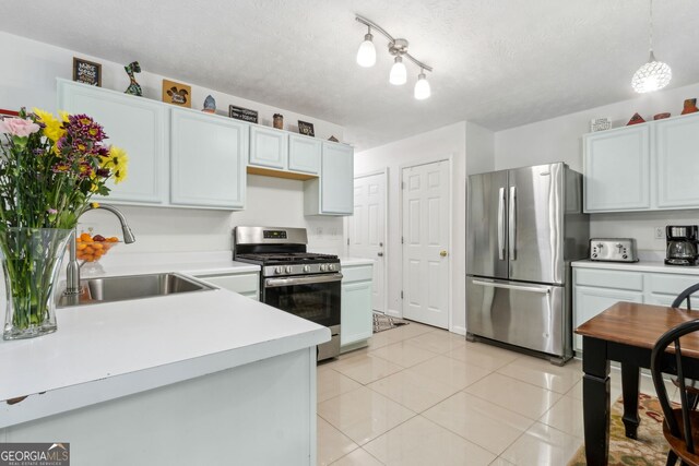 570 White Stag Ct, Suwanee, GA 30024 - kitchen with appliances with stainless steel finishes, light countertops, light tile patterned floors, a textured ceiling, and pendant lighting