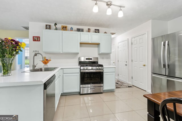 570 White Stag Ct, Suwanee, GA 30024 - kitchen with stainless steel appliances, light countertops, a peninsula, and light tile patterned flooring