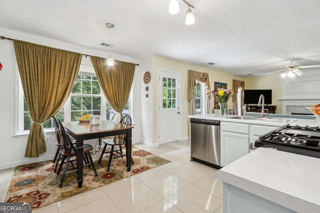 570 White Stag Ct, Suwanee, GA 30024 - kitchen featuring stainless steel dishwasher, ceiling fan, light countertops, light tile patterned floors, and pendant lighting